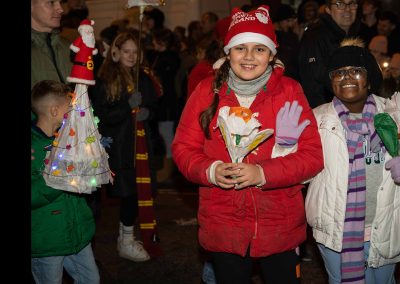 Photo of two young girls on the Totton lantern parade smiling and waving into the camera