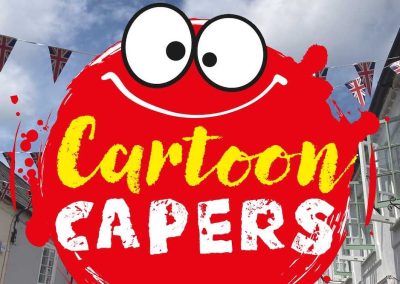 A red cartoon monster is pictured in Hythe Village Centre, New Forest. Text says 'Cartoon Capers'.