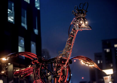 A giant installation of a bird that has started to ignite.