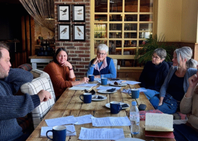 People with notebooks sat around a table